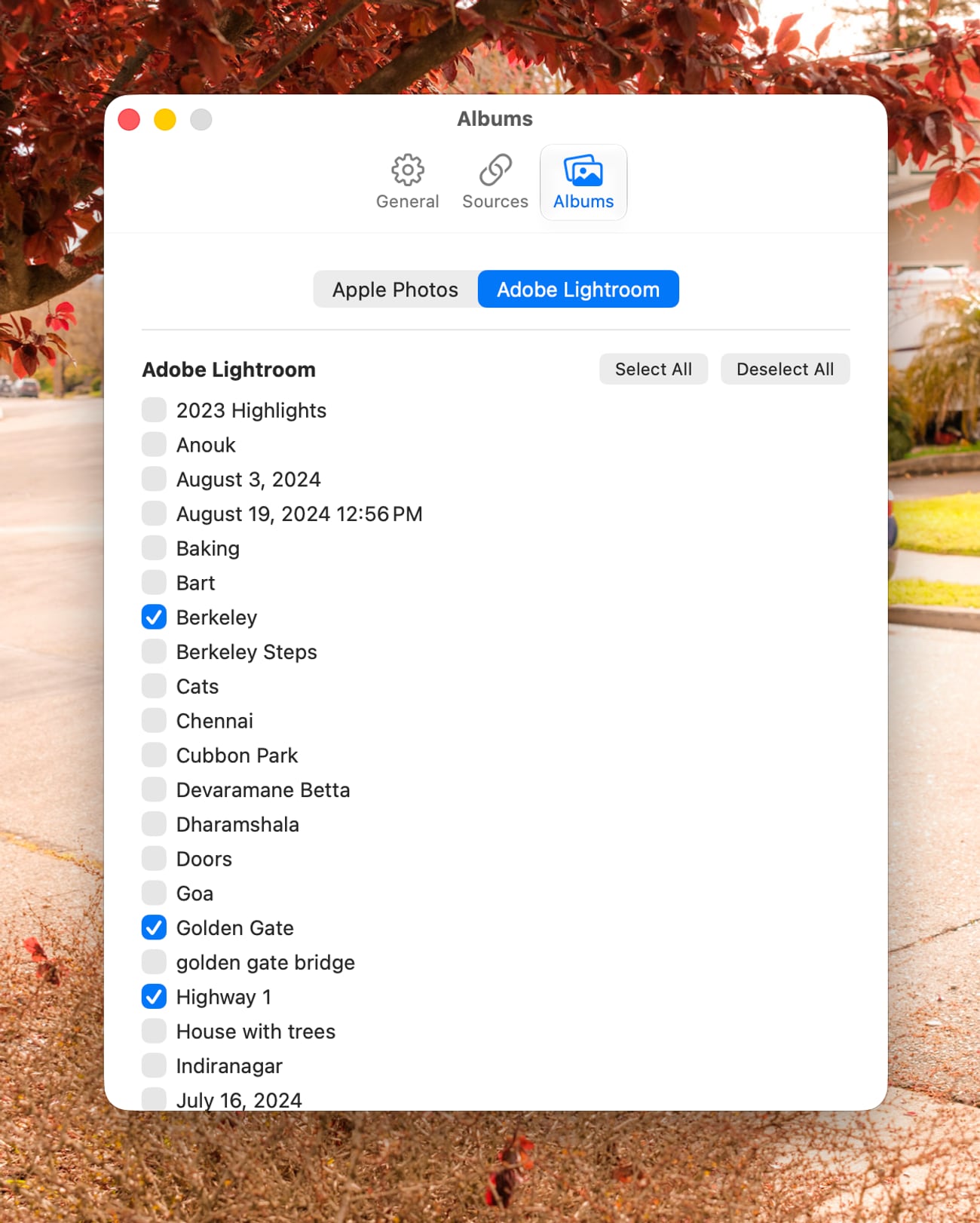 PhotoDrift's Albums settings, showing a scrollable list of Adobe Lightroom albums with checkboxes and Select All and Deselect All buttons.